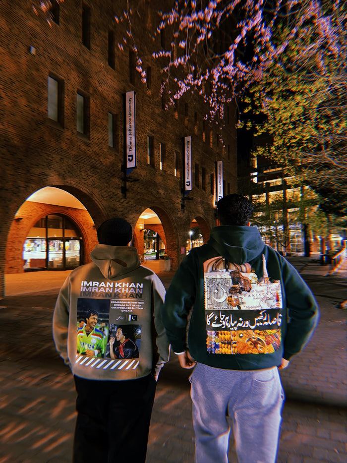 Two friends walking on campus at night in Imran Khan and Made in Pakistan hoodies